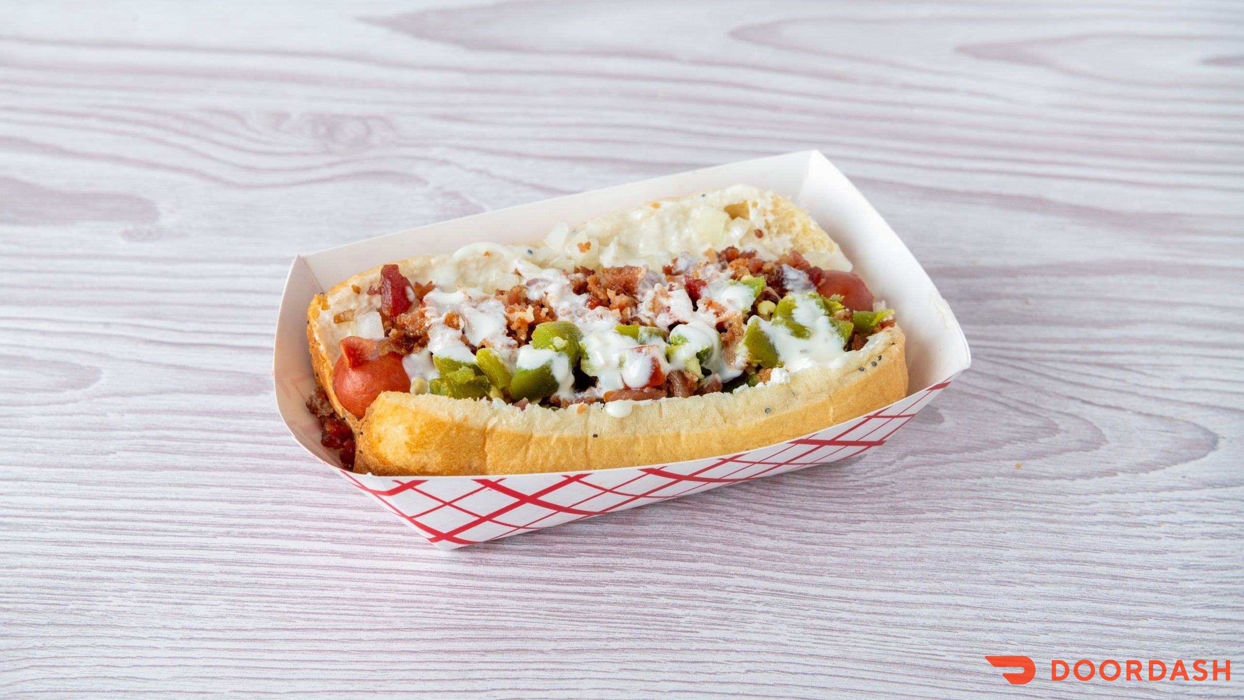 Tex-Mex hot dog with cream cheese, jalapeno, queso, onion and bacon